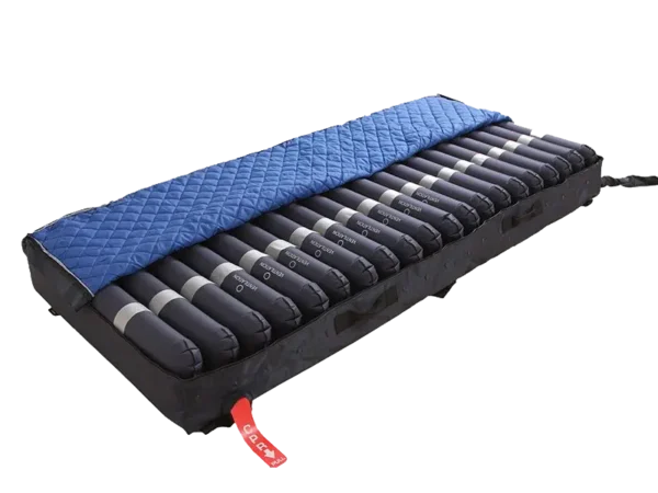 Mattress with cover rolled back to show air cell bladders