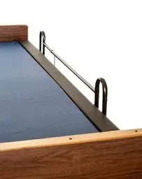 Hospital bed with rail guard in place filling the gap between mattress and bed rail